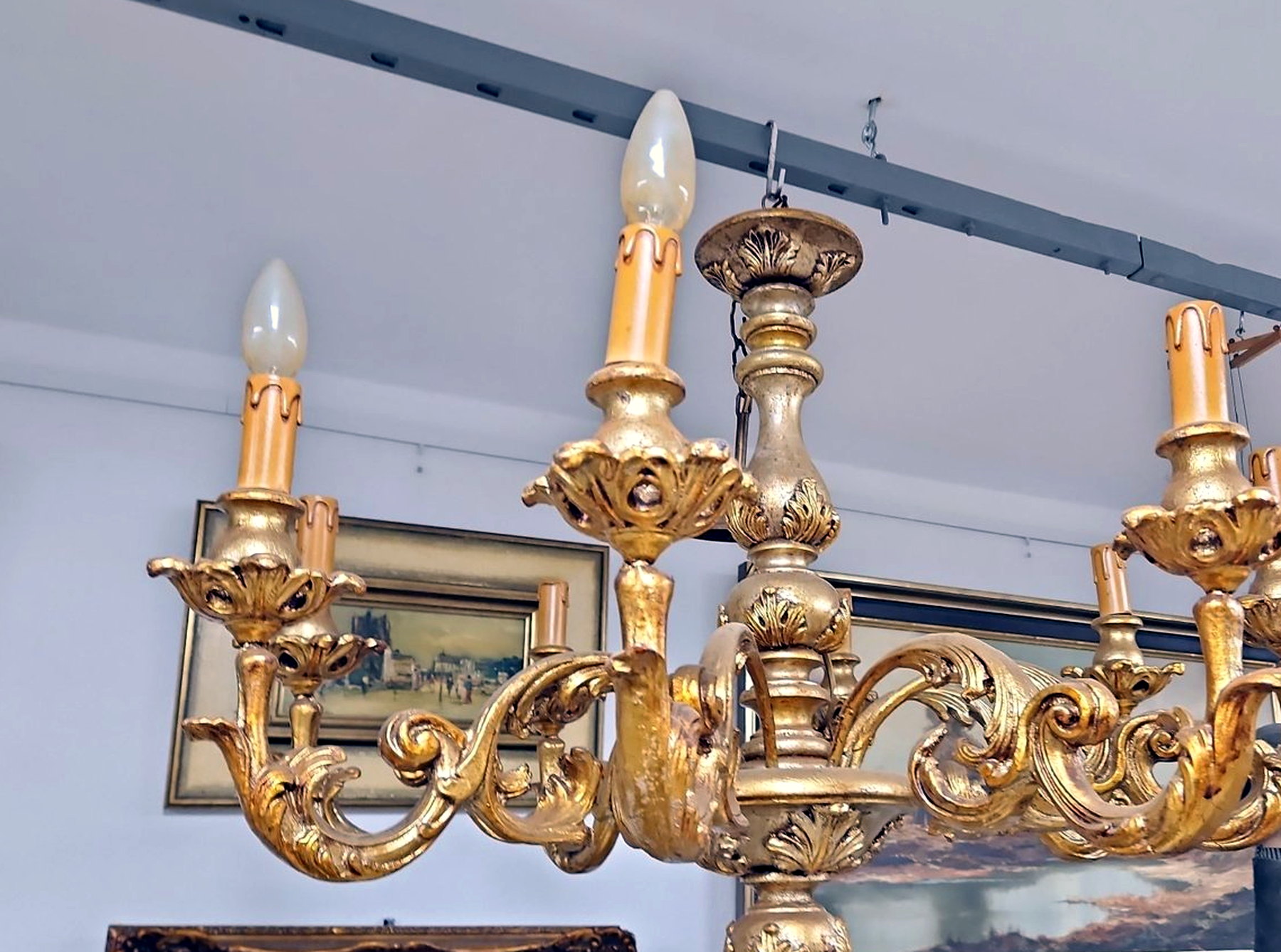 Goldfarbener neobarocker Kronleuchter mit schwungvollen Ornamenten und Kerzentüllen