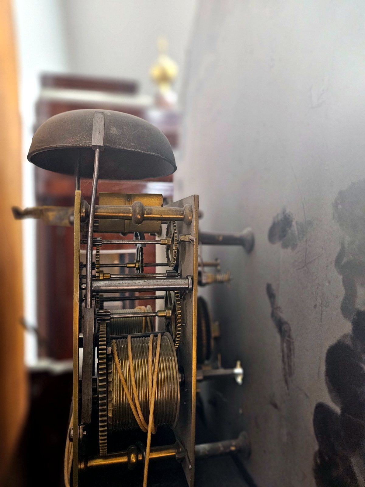 Detailansicht des mechanischen Uhrwerks mit Zahnrädern, Seilzug und Glocke