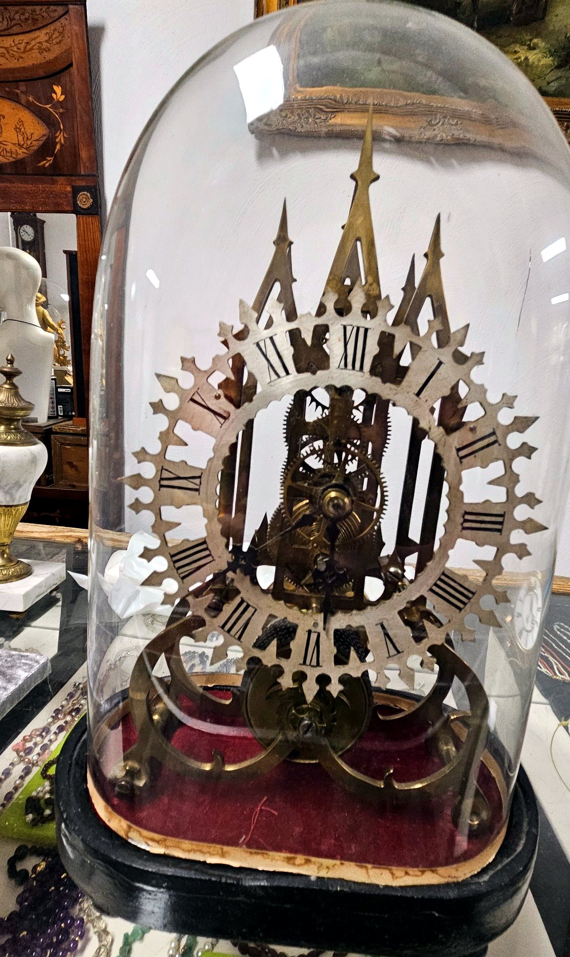 Englische Skelettuhr unter Glasdom mit durchbrochenem Ziffernring und sichtbarem Messingwerk